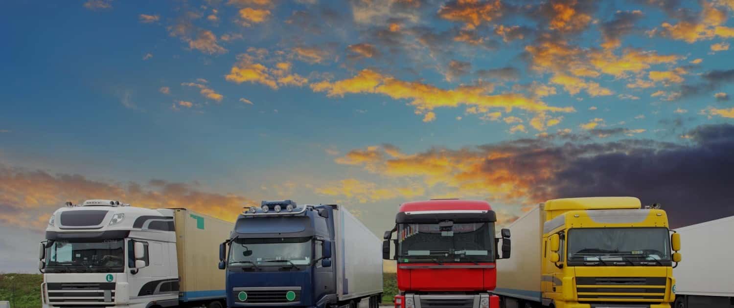 Image of Multiple HGVs on the road - white, blue, red, and yellow