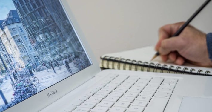 image of person writing on notepad about finance broker, commercial finance broker