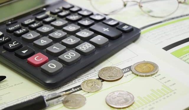 image of calculator with coins and files, Eligible for a Business Loan