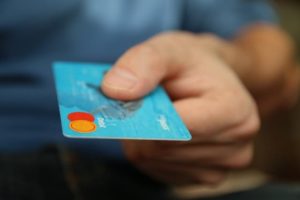 picture of someone handing a credit card over