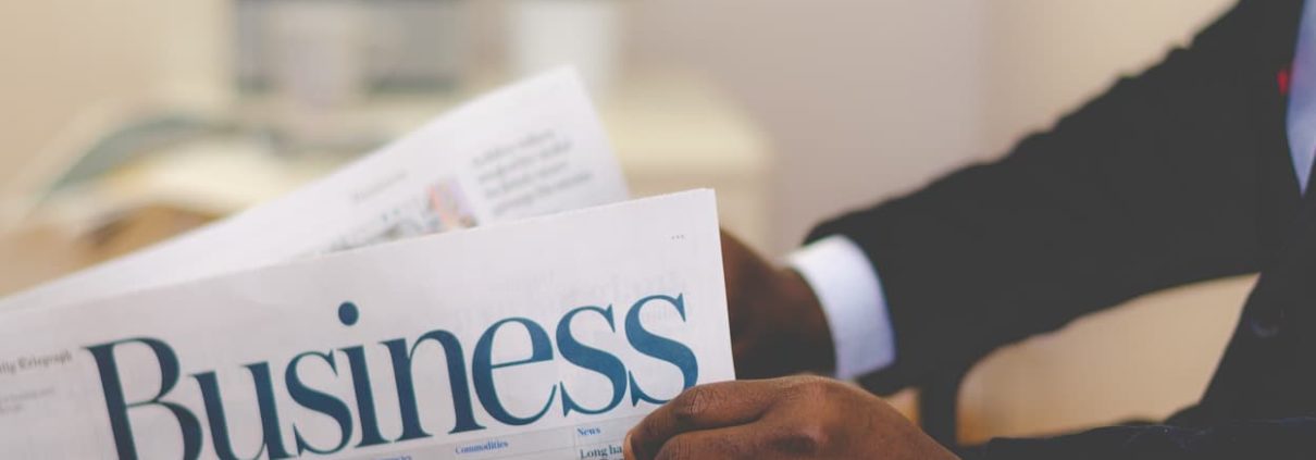 picture of a businessman reading a newspaper, Pick a Loan Broker