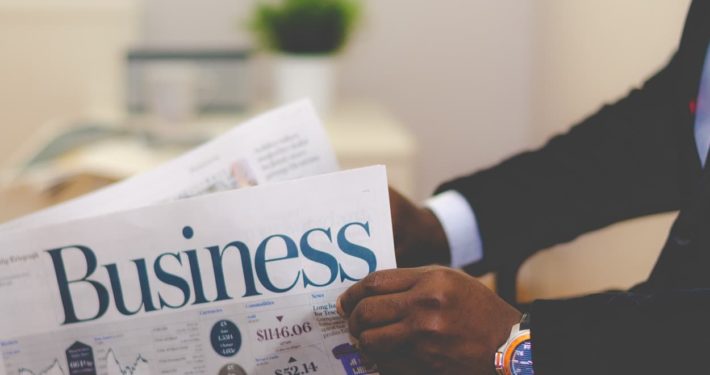 picture of a businessman reading a newspaper, Pick a Loan Broker